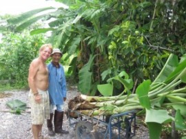 Kevin preparing to plant bananas with our gardener Lung It
