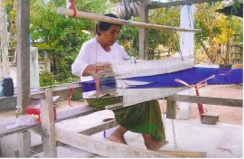 Sula\'s mother Pin hand weaving Thai silk with a traditional loom at her home